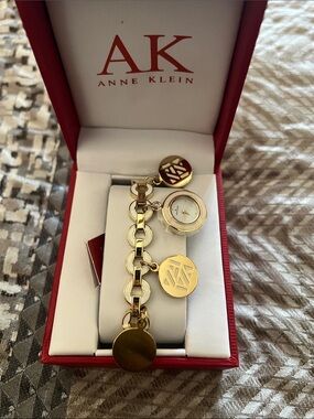 Anne Klein Gold-Tone Charm Bracelet Watch with Logo Discs